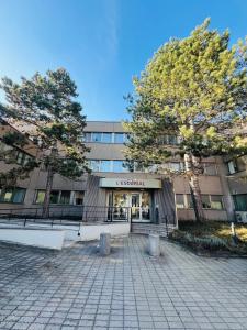 a university building with two trees in front of it at Le Stud in Vandoeuvre-lès-Nancy