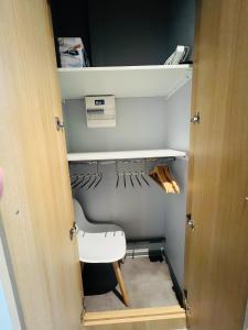 a closet with a door open to a closet with baseball equipment at Le Stud in Vandoeuvre-lès-Nancy +9 photos