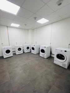 a room with four microwaves and toilets in it at Le Stud in Vandoeuvre-lès-Nancy