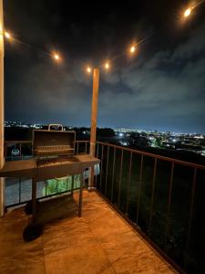 a piano sitting on top of a balcony at night at PH 41 Metepec in Toluca