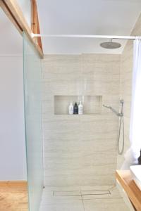 a shower with a glass door in a bathroom at Mr Banks in Robe