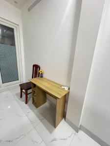 a wooden table and a chair in a room at Anna's House - Hoa Lư in Ninh Binh