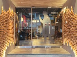a window of a store with a mannequin on the door at Mazor Hotel Hualien Linsen in Hualien City