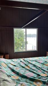 a bedroom with a large bed with a large window at Athulya Tropical Paradise in Paravūr +16 photos