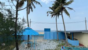 a view of the beach from a house with palm trees at Athulya Tropical Paradise in Paravūr