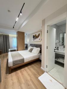 a bedroom with a large bed and a bathroom at Hotel Monaco in Kamëz +40 photos