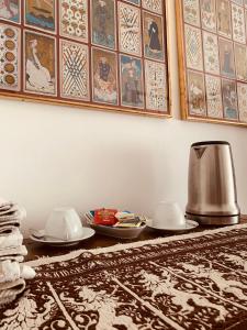 a table with plates and a tea kettle on it at Villa Fiorentino in Ivrea +18 photos