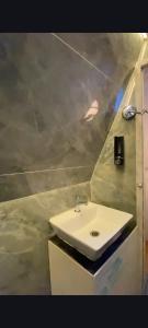 a bathroom with a white sink in a room at Harmony Hills in Bhīra Camp +19 photos