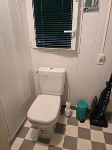 a bathroom with a white toilet and a checkered floor at Studette avec terrasse privée in Saint-Raphaël