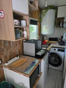 a kitchen with a washer and dryer on a counter at Studette avec terrasse privée in Saint-Raphaël