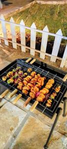 a grill with many different types of food on it at Harmony Hills in Bhīra Camp