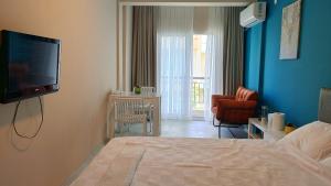 a bedroom with a bed and a tv on a wall at Lemon Garden in Antalya