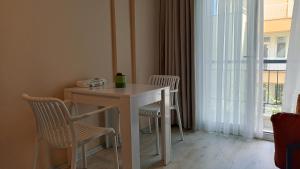 a table and chairs in a room with a window at Lemon Garden in Antalya