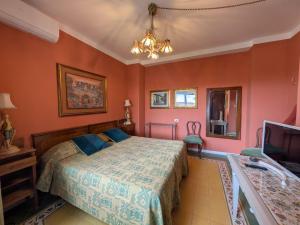 a bedroom with a bed and a tv in it at Relais La Canfora in Rome