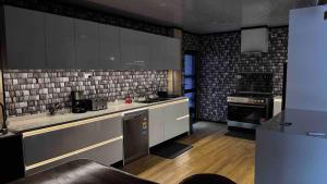 a kitchen with black and white tiles on the wall at Raza villa in Lautoka