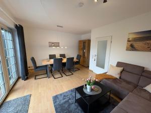 a living room with a couch and a table at Achterdeck Kajüte in Dornumersiel