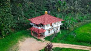an aerial view of a house with a red roof at Brookfield estate villa 2bhk in Madikeri
