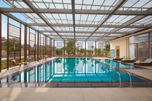 a large swimming pool with a large glass ceiling at Vivanta Ekta Nagar in Kevadia