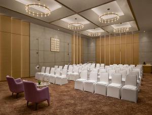a large room with white chairs and tables and lights at Vivanta Ekta Nagar in Kevadia +34 photos