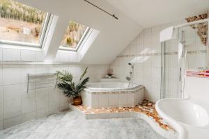a white bathroom with a tub and a sink at Landhaus Zitz in Ranten +57 photos