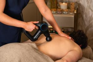 a woman giving a man a hair dryer at Francis Hotel Bath in Bath