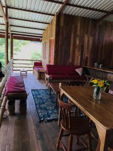 a living room with a table and a couch at Rancho Ecojoya Paradise Mountain working farm in nature in San Isidro de El General