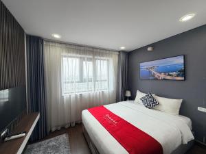 a bedroom with a large bed and a window at Ha Long 2BR Apartment - Spacious & Modern - Near Center in Ha Long