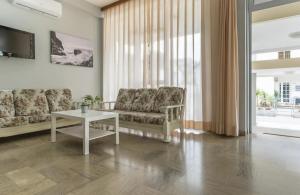 a living room with a couch and a table at Hotel Levante Convenzionato con ACQUARIO DI CATTOLICA in Riccione