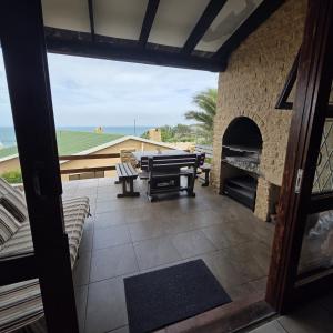 a patio with a picnic table and a fireplace at Allesreg Holiday Home in Margate