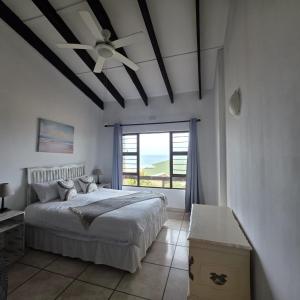 a bedroom with a bed and a ceiling fan at Allesreg Holiday Home in Margate