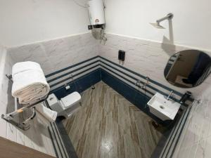a bathroom with two sinks and a mirror at A One Residency in Bahora