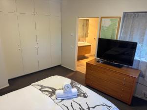a bedroom with a tv on a dresser and a bed at Mark II 3W in Mount Buller