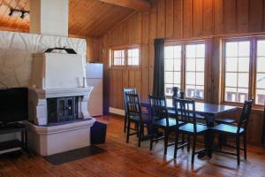 a dining room with a table and a fireplace at Haugsynlies sjarm in Beitostøl