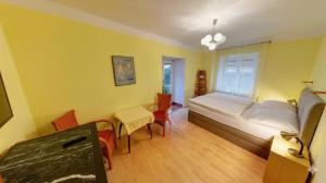 a bedroom with a bed and a table and chairs at Pension Siesta in Třeboň