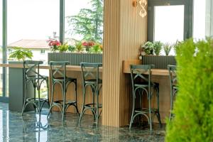 a bar with stools in a room with windows at Air Barbaros Hotel Trabzon in Trabzon +43 photos