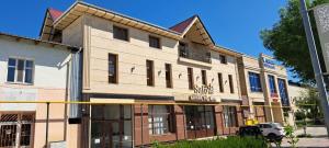 a building on the corner of a street at Safo Hotel Turkestan in Türkistan