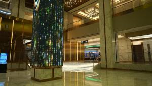 a christmas tree in the middle of a building at New Coast Hotel Manila in Manila