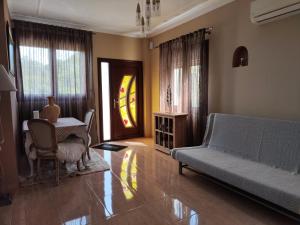 a living room with a couch and a table at Gavrilis apartments II in Nénita