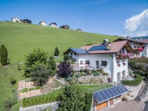 an aerial view of a house with solar panels on it at Arbea Apartments in Ortisei