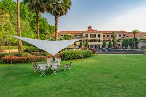 a group of chairs and a tent in a yard at Hangzhou Rose Garden Resort & Spa in Hangzhou