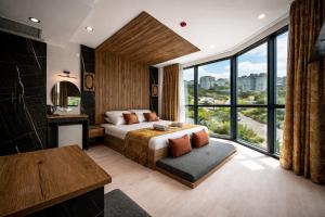 a bedroom with a bed and a large window at Air Barbaros Hotel Trabzon in Trabzon
