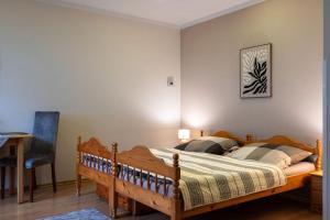a bedroom with a wooden bed and a desk at Apartment Sučany in Sučany