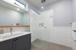 a bathroom with a sink and a shower at Wilson's Beach Beauty in Inverloch +15 photos