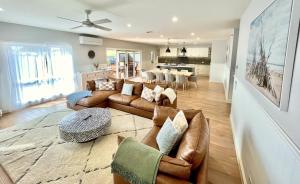 a living room with a couch and a table at Wilson's Beach Beauty in Inverloch