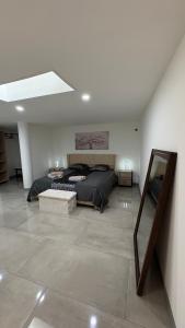 a bedroom with a bed and a mirror at rozormant in Rosporden