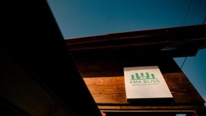 a sign for an amazon business on a building at AMA Bliss Nature & Cozy Cabin in Avrig