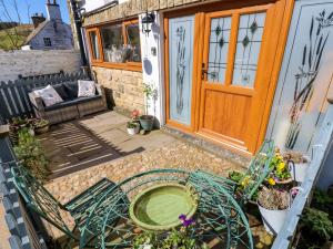 a patio with a glass table and a door at The Museum in Alston