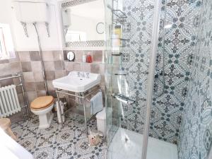 a bathroom with a toilet and a sink and a shower at The Museum in Alston +43 photos