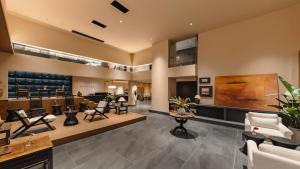 a waiting room with chairs and a salon at Wuye WOO YEAH Tangchi Hotel in Emeishan City