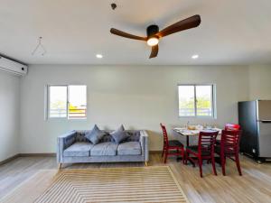 a living room with a couch and a table with chairs at Tiffany Resident Apartment in Siem Reap